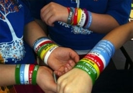 Students wear colorful wristbands to promote the Roots program. Photo courtesy of Elizabeth Levy Paluck, Princeton University.