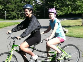 Maddy Mau who si blind, cycling with her sister.